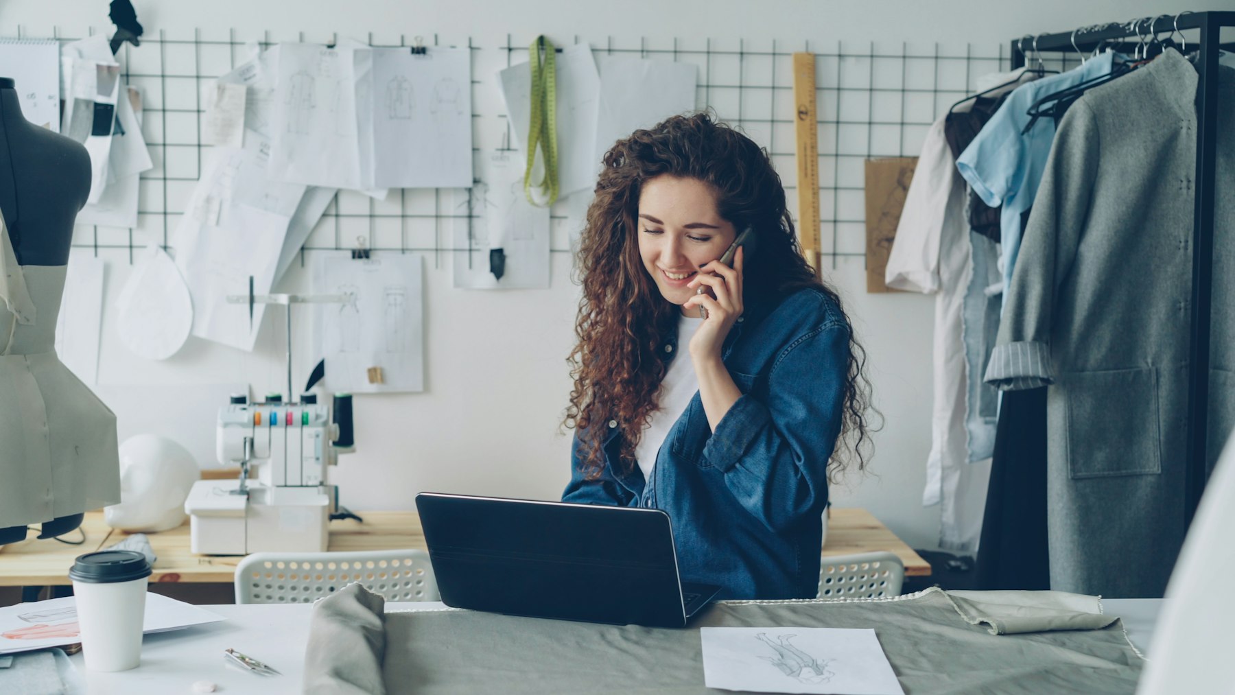 Small business owner on the phone at her laptop