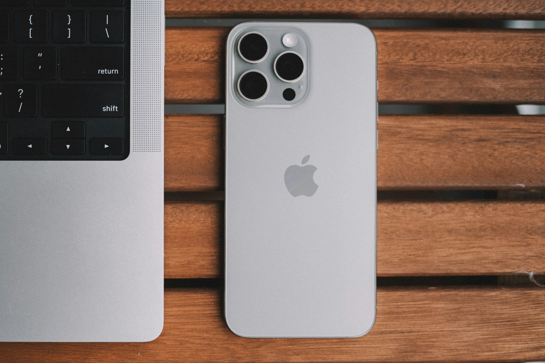 iPhone and MacBook on a desk