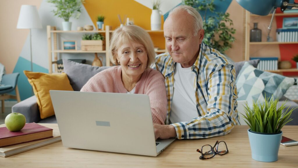Senior couple using a laptop together at home