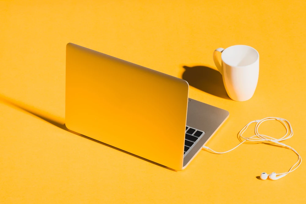 Laptop on a yellow background